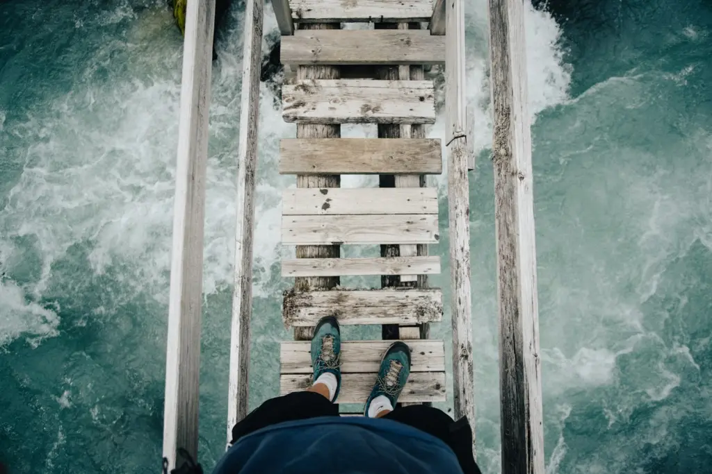 Person standing on wooden bridge